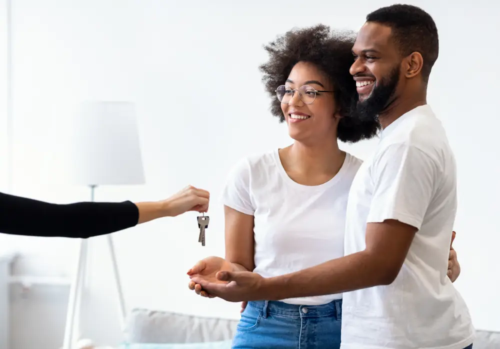 A happy couple being given keys to their new home