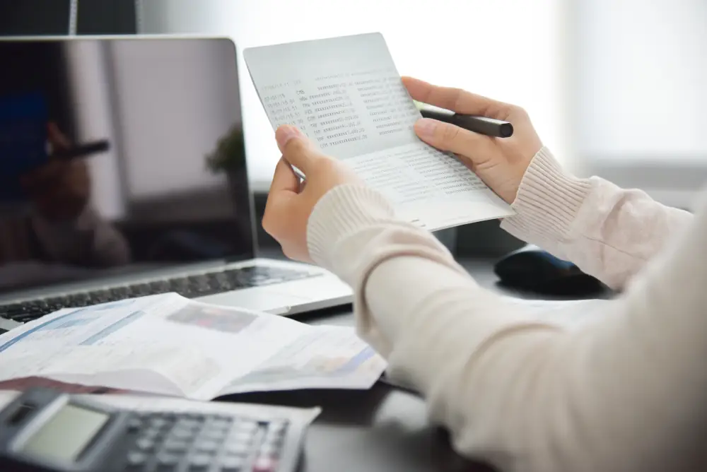 Someone holding a document at their desk