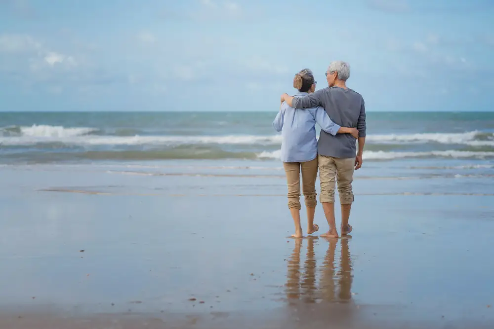 An elderly couple looking out at the ocean